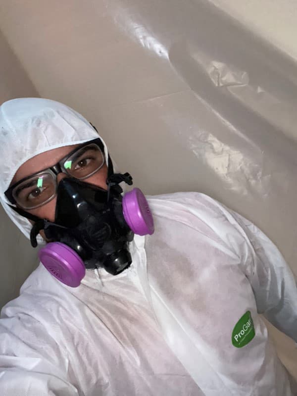 Swift Restoration technician in full PPE inside mold containment